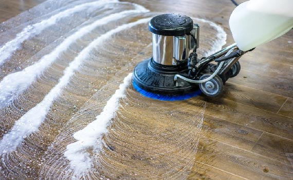 a person cleaning a laminate floor